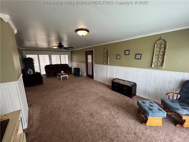 living area featuring crown molding and carpet flooring