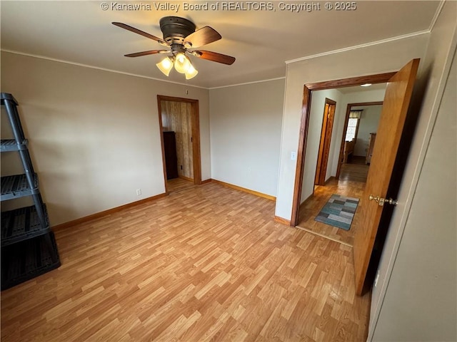 spare room featuring ornamental molding, ceiling fan, and light wood-type flooring