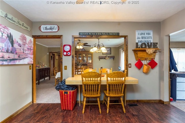 dining room with an inviting chandelier and dark hardwood / wood-style flooring