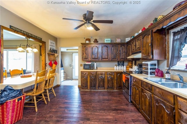 kitchen featuring dark wood-type flooring, sink, dark brown cabinets, hanging light fixtures, and stainless steel electric stove