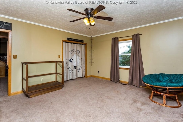 unfurnished room featuring ornamental molding, light colored carpet, ceiling fan, and a textured ceiling