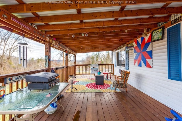 wooden deck featuring a grill and a fire pit