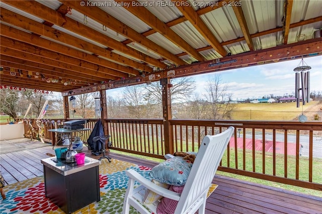 wooden deck featuring a lawn