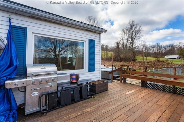 wooden terrace with a grill