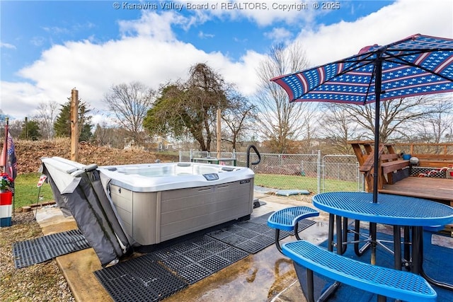 view of patio / terrace with a hot tub and a wooden deck