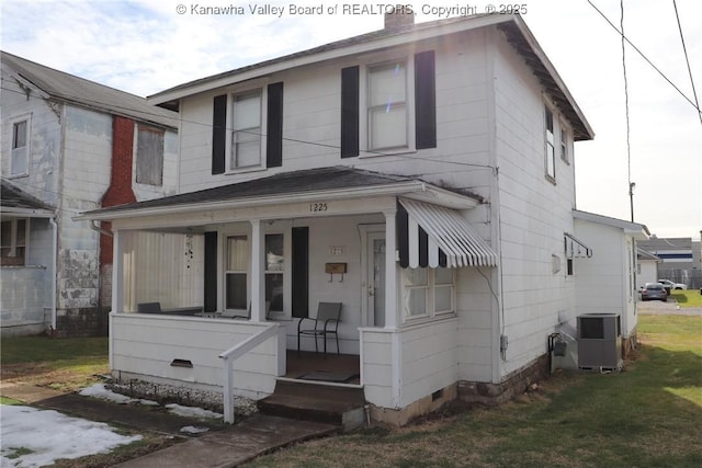 view of front of home with a porch, a front yard, and central air condition unit