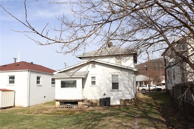 back of property featuring a lawn