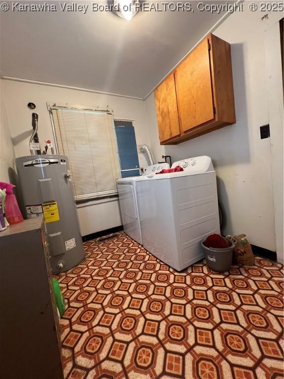 laundry room featuring cabinets, washer and clothes dryer, and water heater