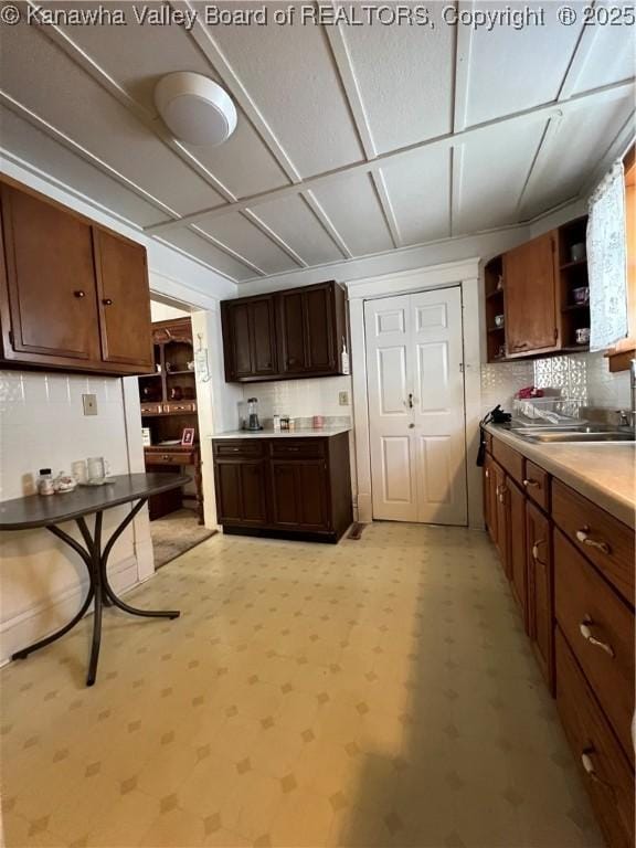 kitchen with dark brown cabinets and backsplash