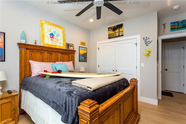 bedroom with ceiling fan, a closet, and light hardwood / wood-style flooring