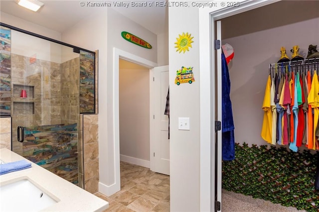 bathroom with vanity and a shower with door