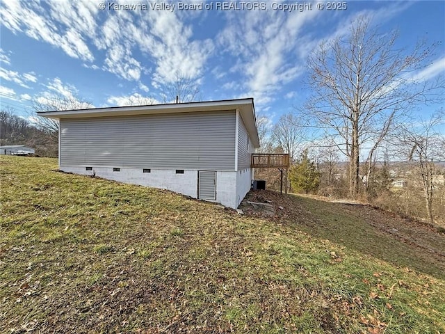 view of property exterior with a yard and a deck