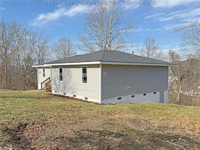 view of side of home with a yard