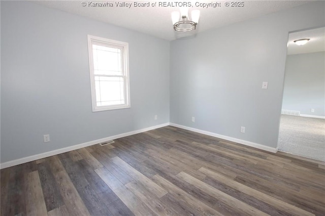 spare room featuring dark wood-type flooring