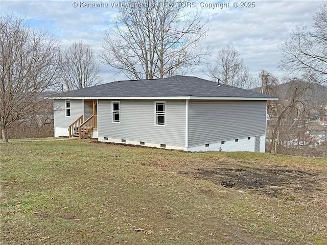 rear view of property featuring a yard