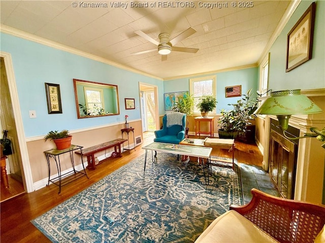 sitting room featuring dark hardwood / wood-style flooring, ornamental molding, and ceiling fan