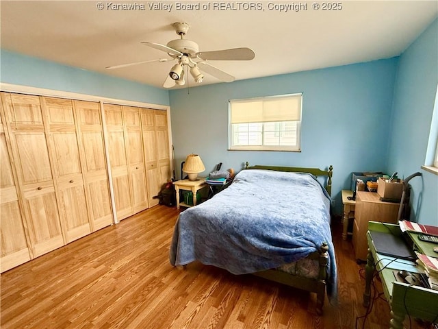 bedroom with ceiling fan, light hardwood / wood-style floors, and a closet