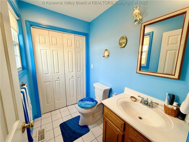 bathroom with vanity, toilet, and tile patterned flooring