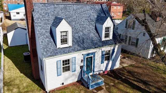 view of front of property with central AC unit and a front yard