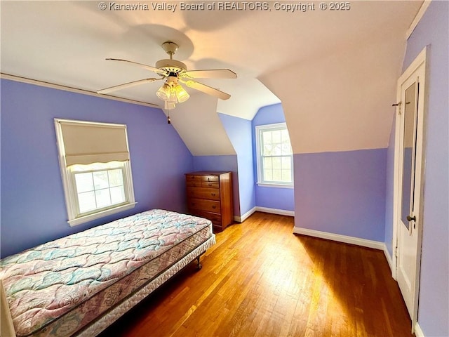 bedroom featuring ceiling fan, lofted ceiling, and wood-type flooring