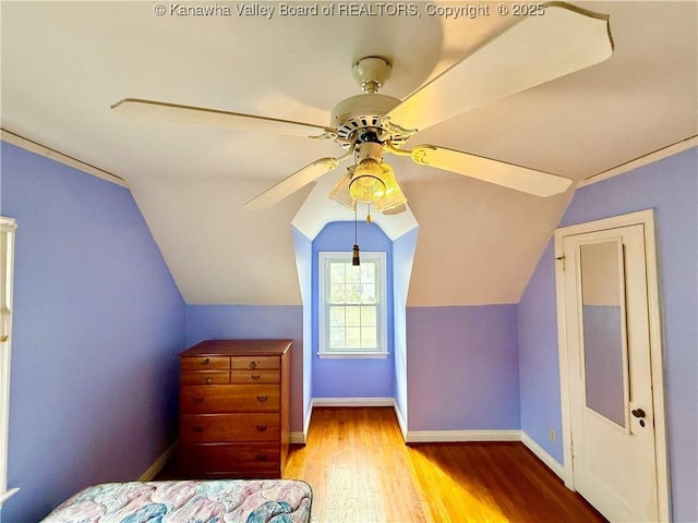 bedroom with lofted ceiling, light hardwood / wood-style flooring, and ceiling fan