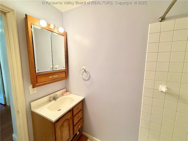 bathroom with walk in shower and vanity