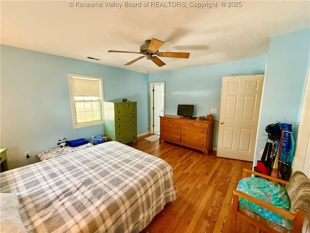 bedroom featuring ceiling fan and hardwood / wood-style floors