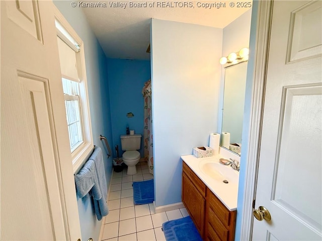 bathroom featuring vanity, toilet, and tile patterned flooring