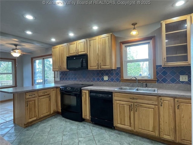 kitchen featuring light tile patterned flooring, black appliances, sink, backsplash, and kitchen peninsula