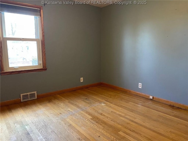 spare room featuring light hardwood / wood-style flooring