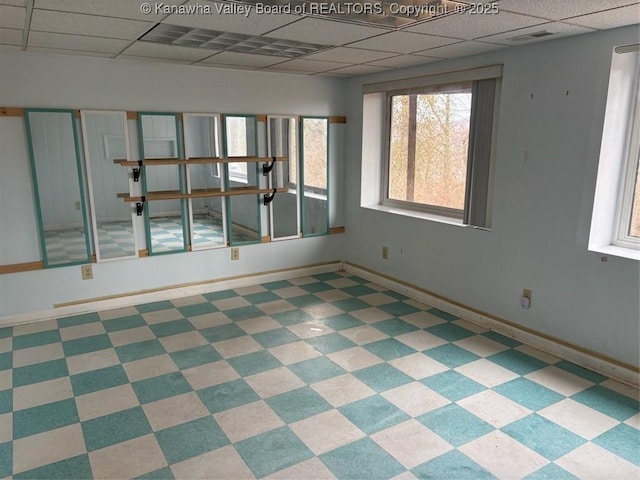 spare room with a paneled ceiling