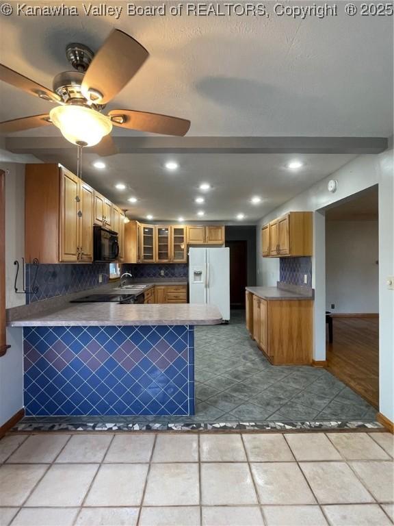 kitchen with light tile patterned floors, decorative backsplash, white fridge with ice dispenser, and kitchen peninsula