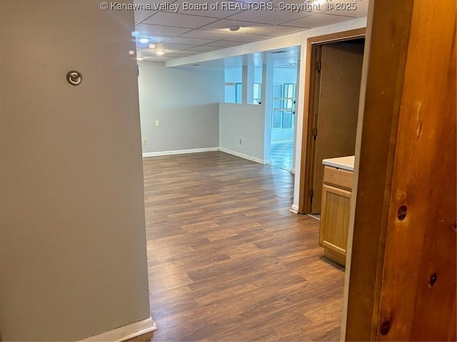 interior space with dark hardwood / wood-style floors and a paneled ceiling