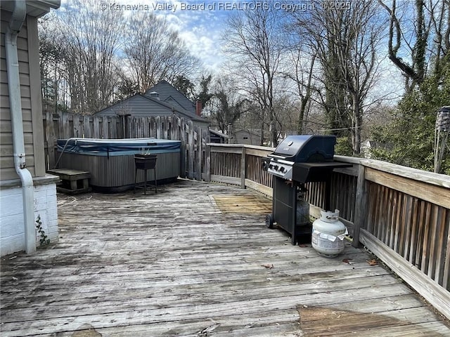 wooden deck featuring a grill and a hot tub