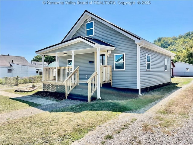 view of front facade with covered porch and a front yard