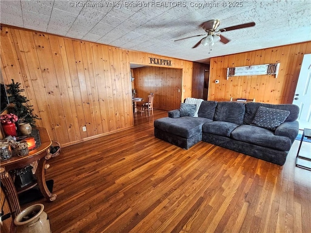 living room featuring hardwood / wood-style floors and ceiling fan