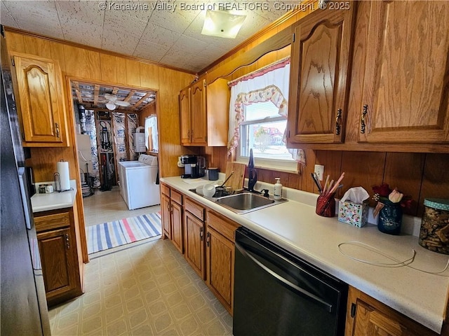 kitchen with wooden walls, washer / clothes dryer, dishwasher, sink, and ornamental molding