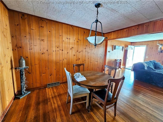 dining space featuring dark wood-type flooring