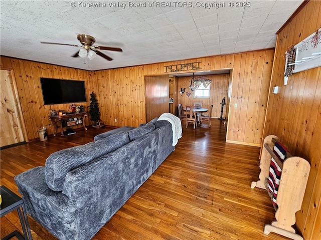 living room featuring hardwood / wood-style flooring and ceiling fan