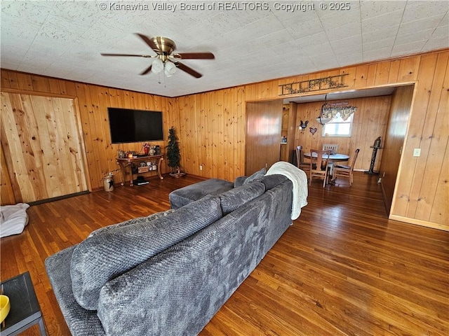 living room with dark wood-type flooring and ceiling fan