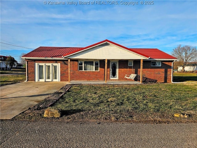 single story home with a front lawn and french doors