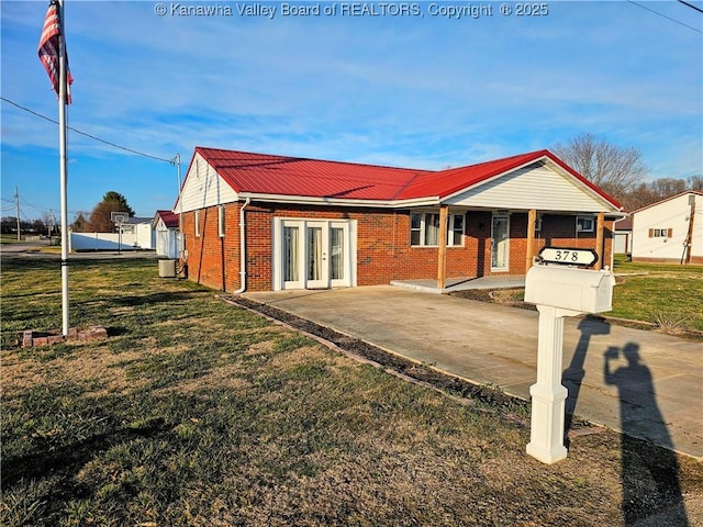 single story home featuring french doors and a front lawn