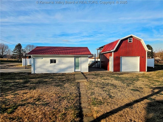 view of outbuilding featuring a garage and a yard