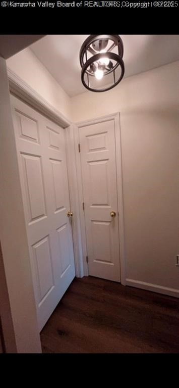 doorway to outside with baseboards and dark wood-style floors