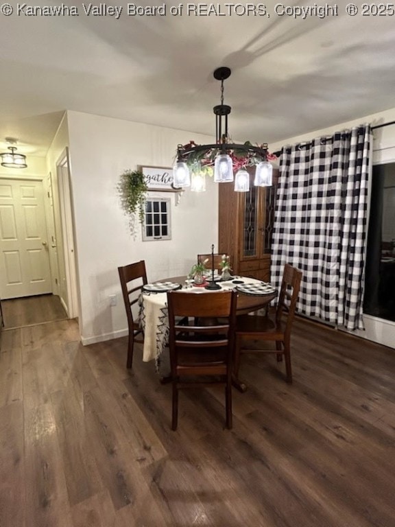 dining area featuring baseboards and dark wood finished floors