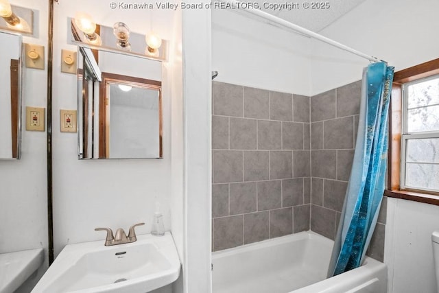 full bathroom featuring shower / bath combo, sink, and toilet