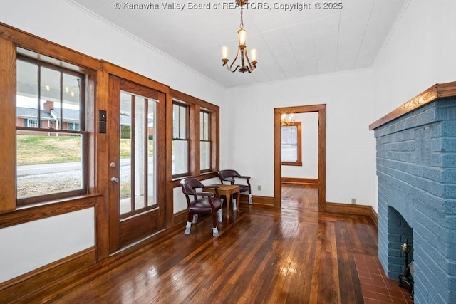 interior space featuring dark hardwood / wood-style flooring, ornamental molding, and a chandelier