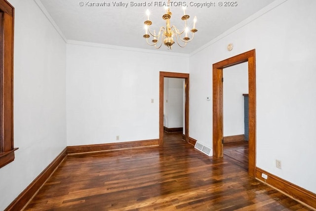 empty room featuring crown molding, a notable chandelier, and dark hardwood / wood-style flooring