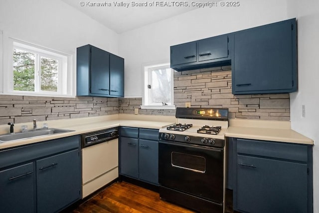 kitchen with gas stove, dishwasher, sink, and blue cabinetry