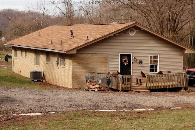 view of front of property featuring a wooden deck and central AC unit